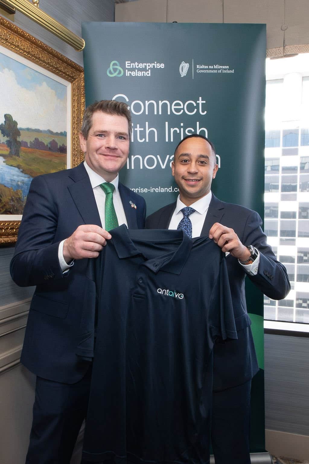 Peter Burke, Ireland’s Minister for Enterprise, Tourism and Employment, and Noah Wilson of Cora Systems holding an antaivo polo shirt